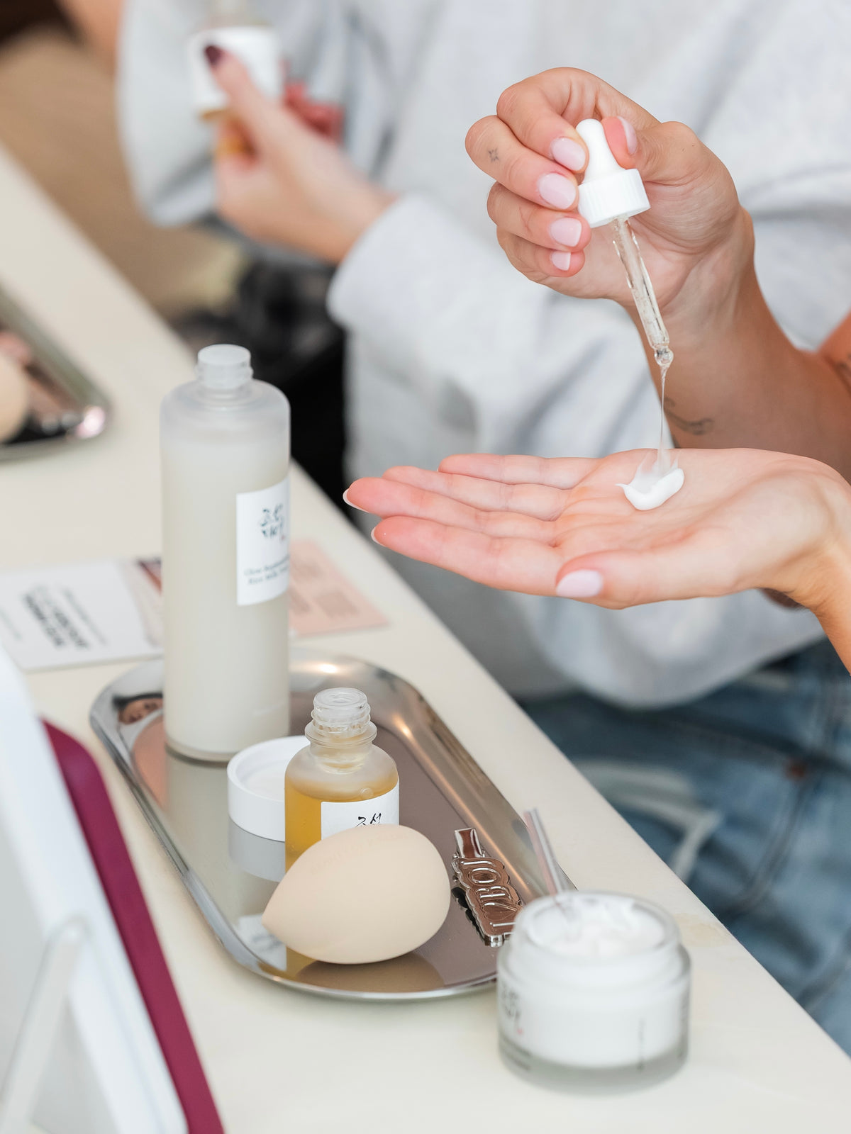 A Beauty of Joseon product is being applied to a hand using a dropper.