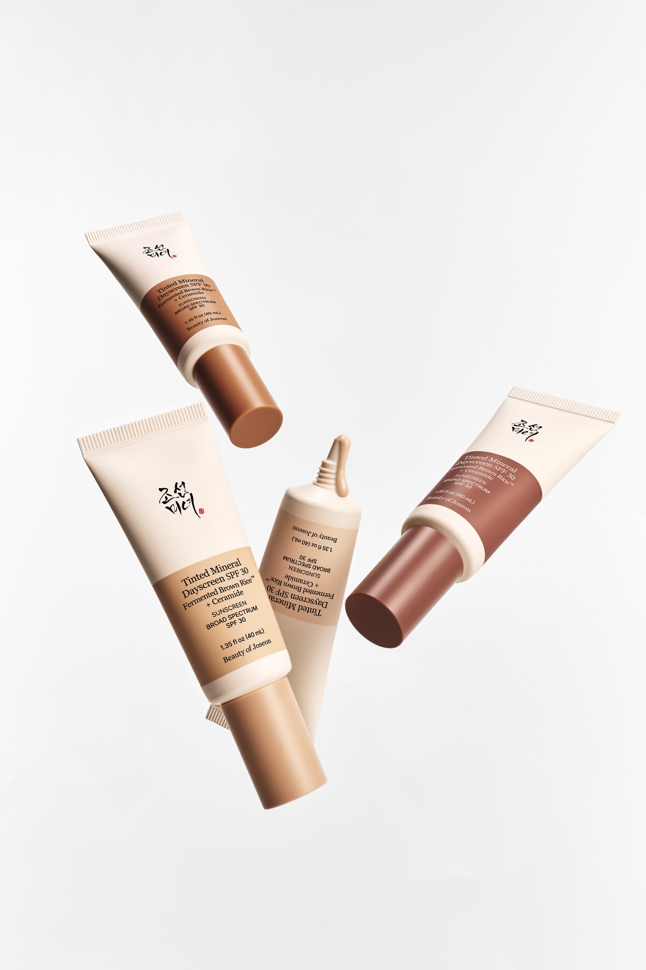 Four Beauty of Joseon Tinted Mineral Day Screen products are placed against a gray-toned background.